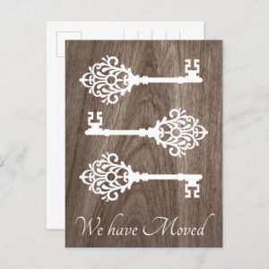Moving announcement with vintage keys on wood postcard