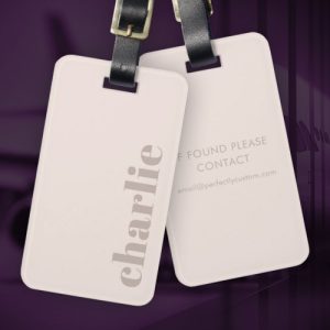 Modern minimal luggage tag with custom name on muted pink background and customizable text on back