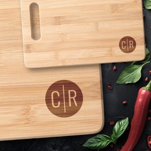 Modern monogram initials on dark circle cutting board