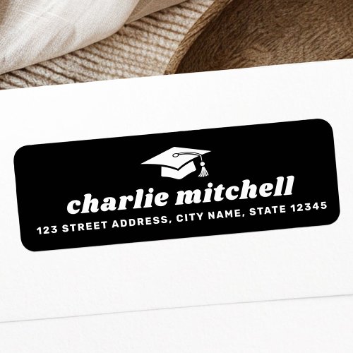 Custom graduation return address label with black background, white grad cap icon, and bold retro name.