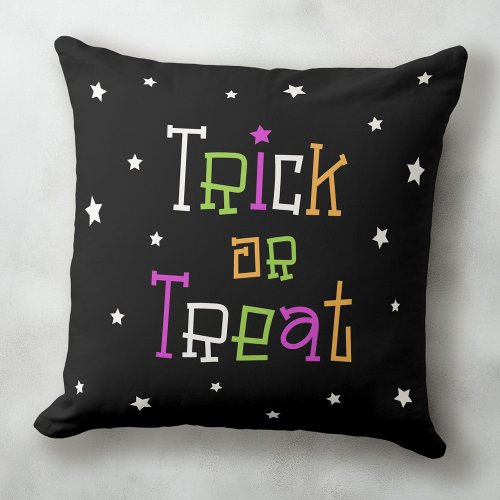 Black Trick or treat Halloween accent pillow with fun typography and white stars