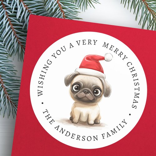 Round Christmas sticker with cute pug in Santa hat and customizable family name.